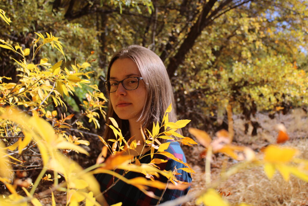 A photo of Emily Scott in the woods. 